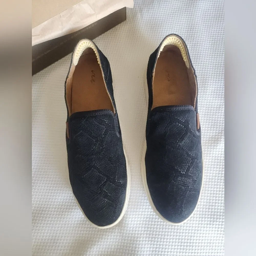OluKai Black and White Flats Sleek Slip-On Design
